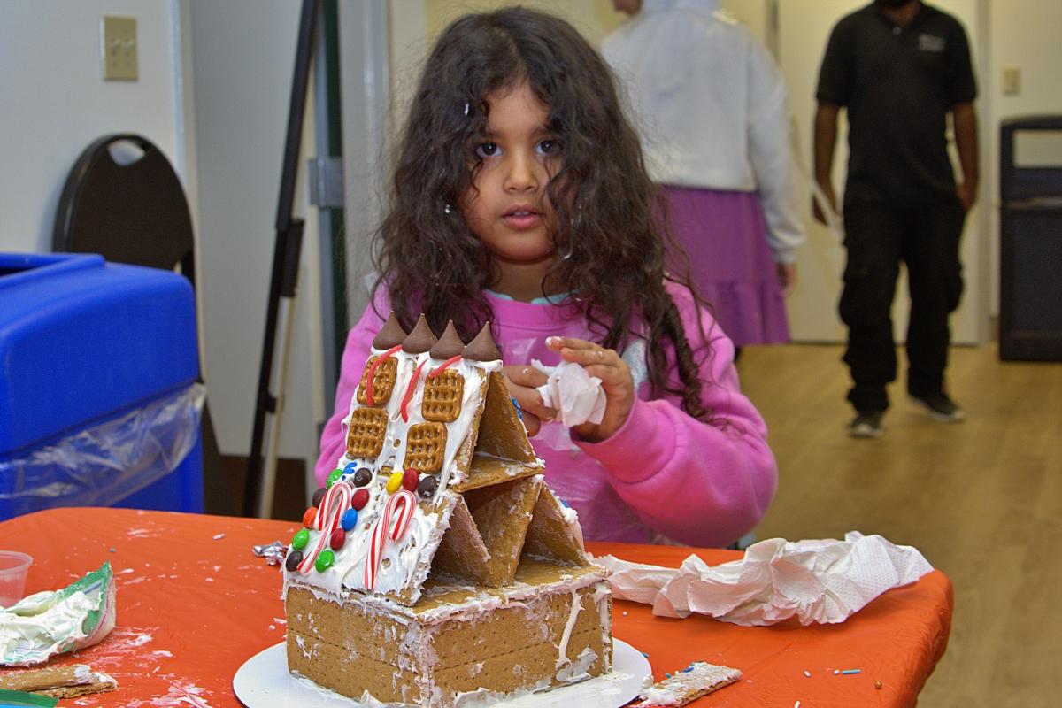 A girl putting the finishing touches on her house
