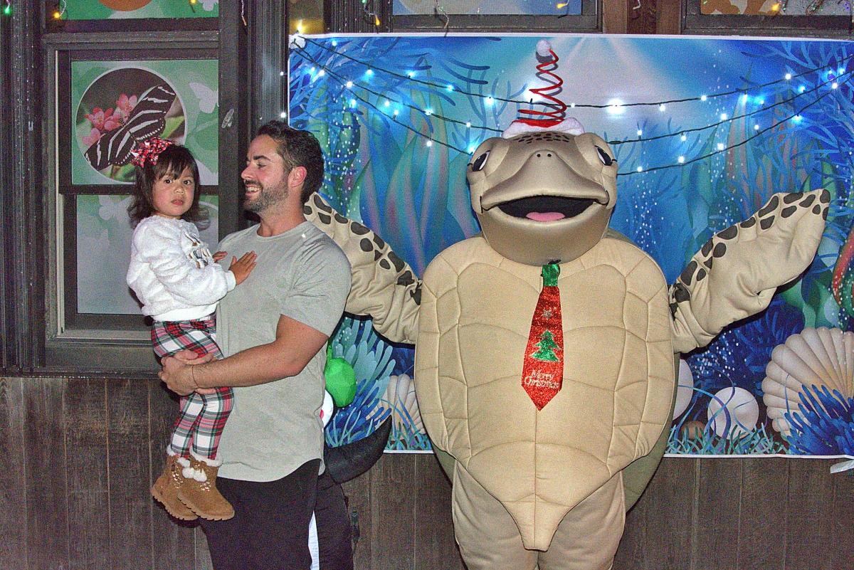Father and daughter with turtle mascot Luna