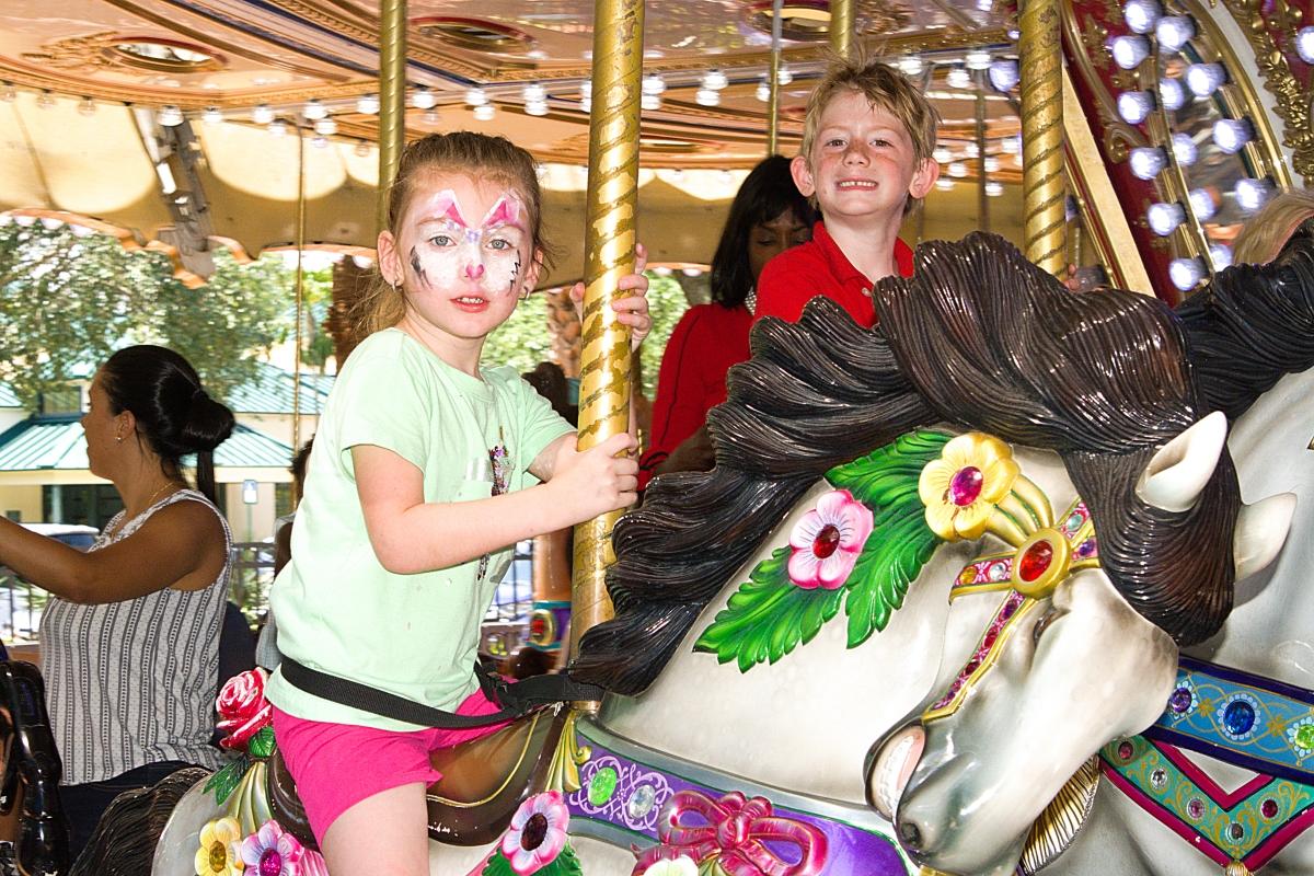 Boy and girl on carousel