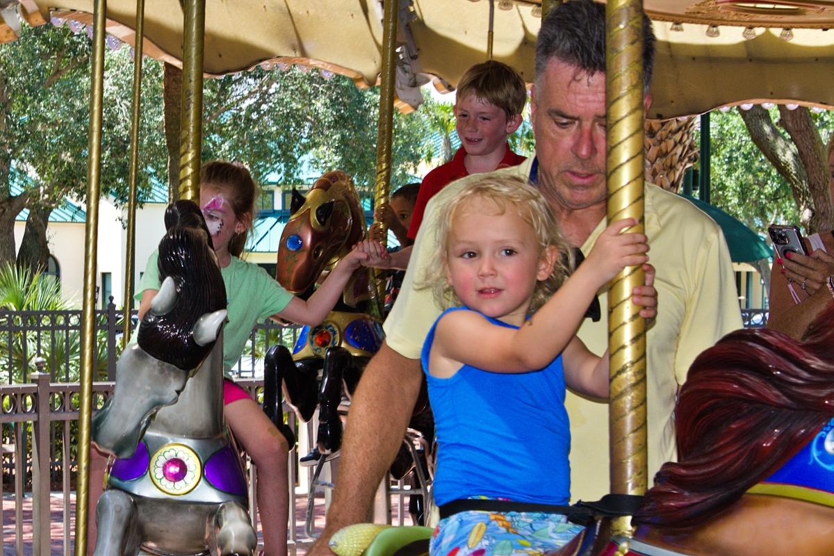 Child enjoying carousel spin