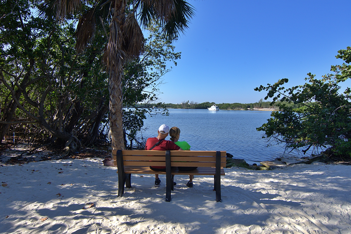 Two people on a bench looking at the Intracoastal