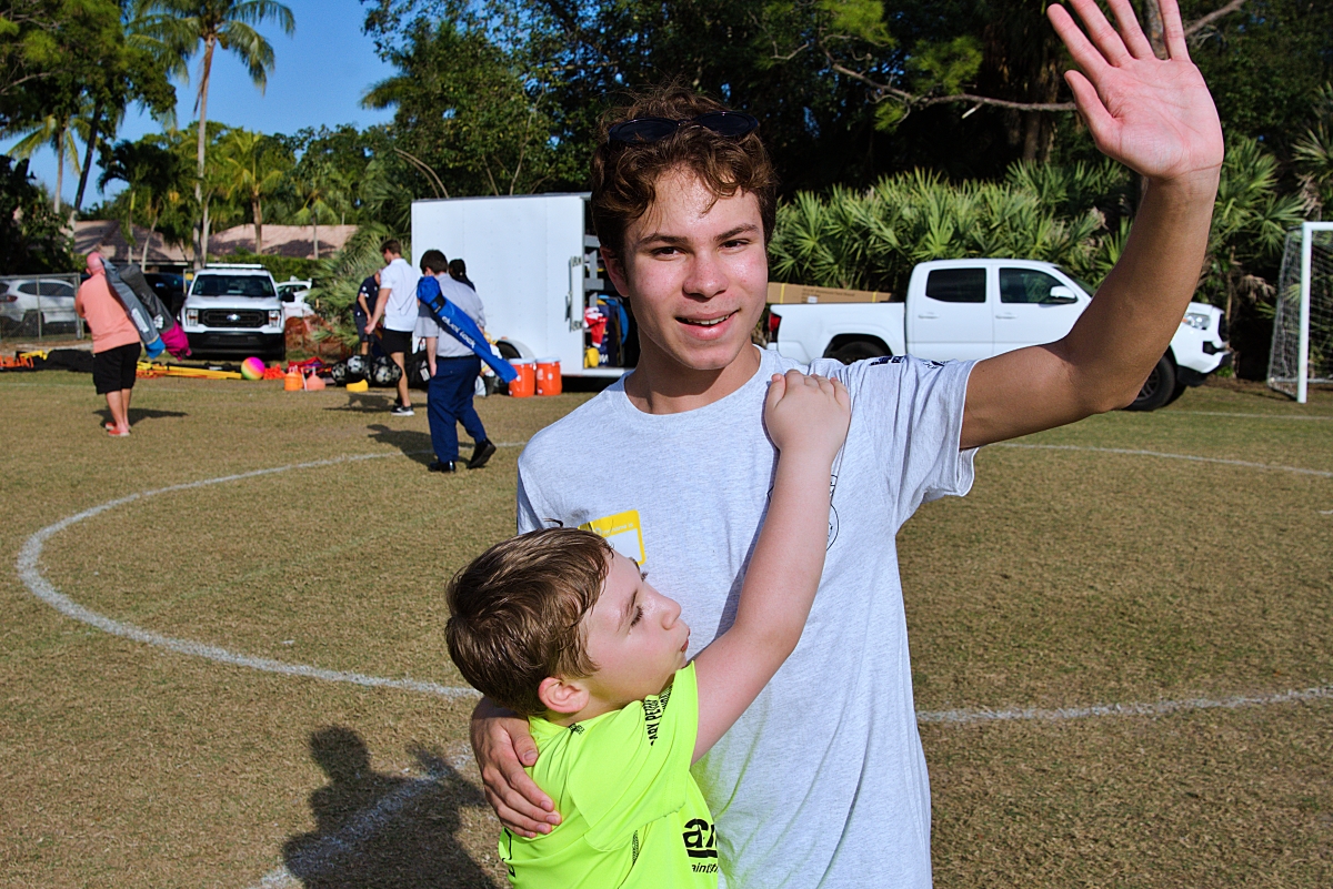 Eric Ehrnst waves as he receives a hug from Jordan Ogman